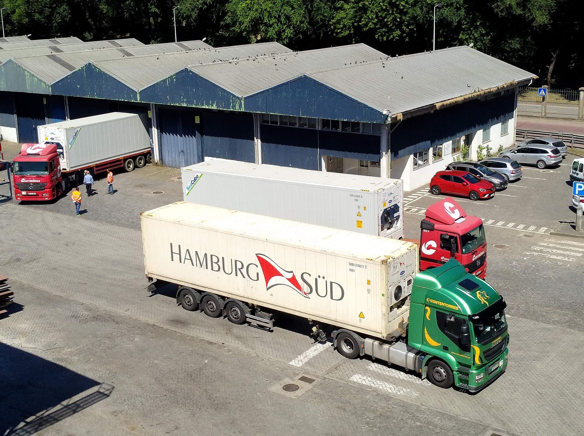 A refrigerated container mounted on a wheeled chassis at a port.