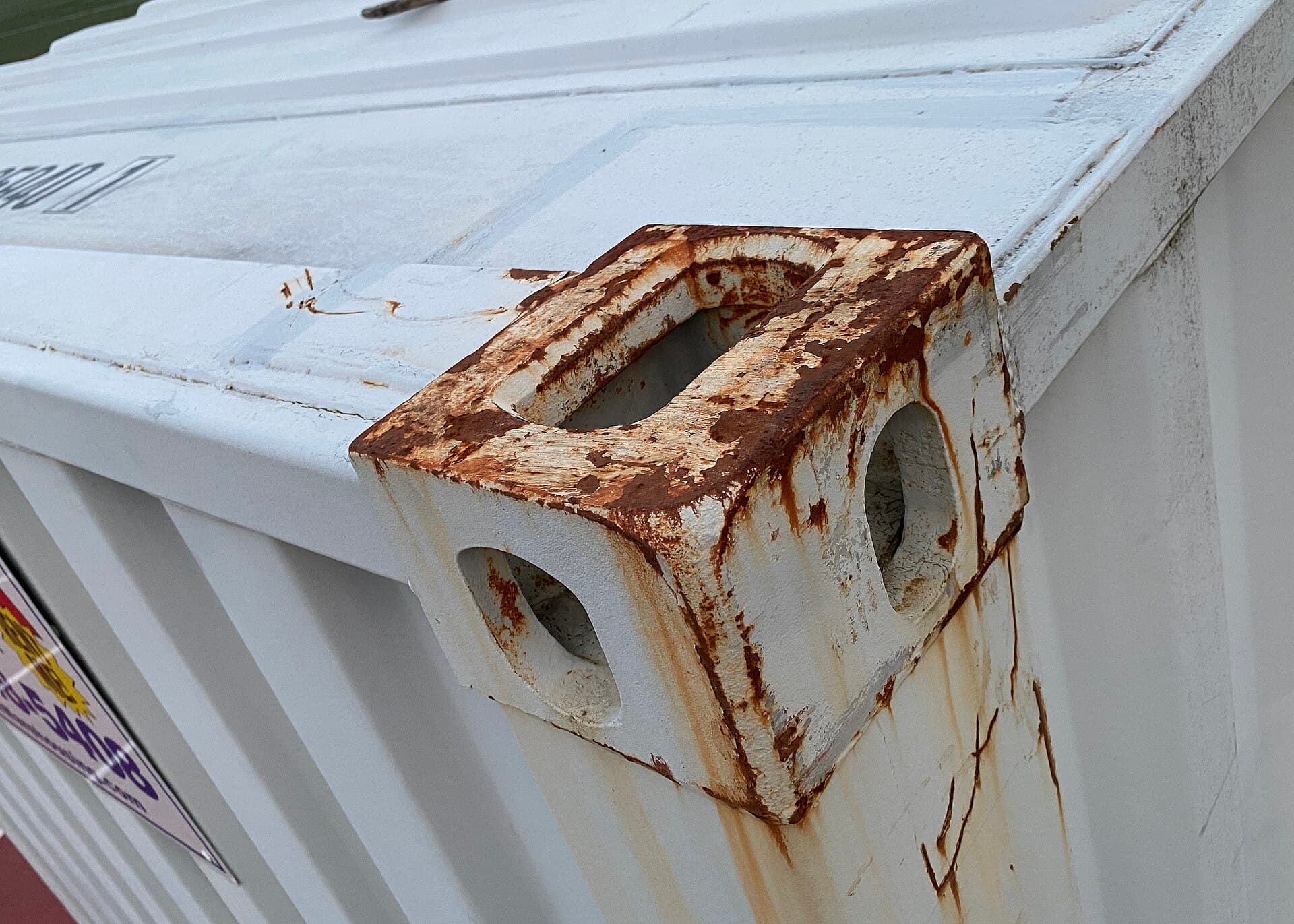 A twist-lock connector securing a container at its corner casting.